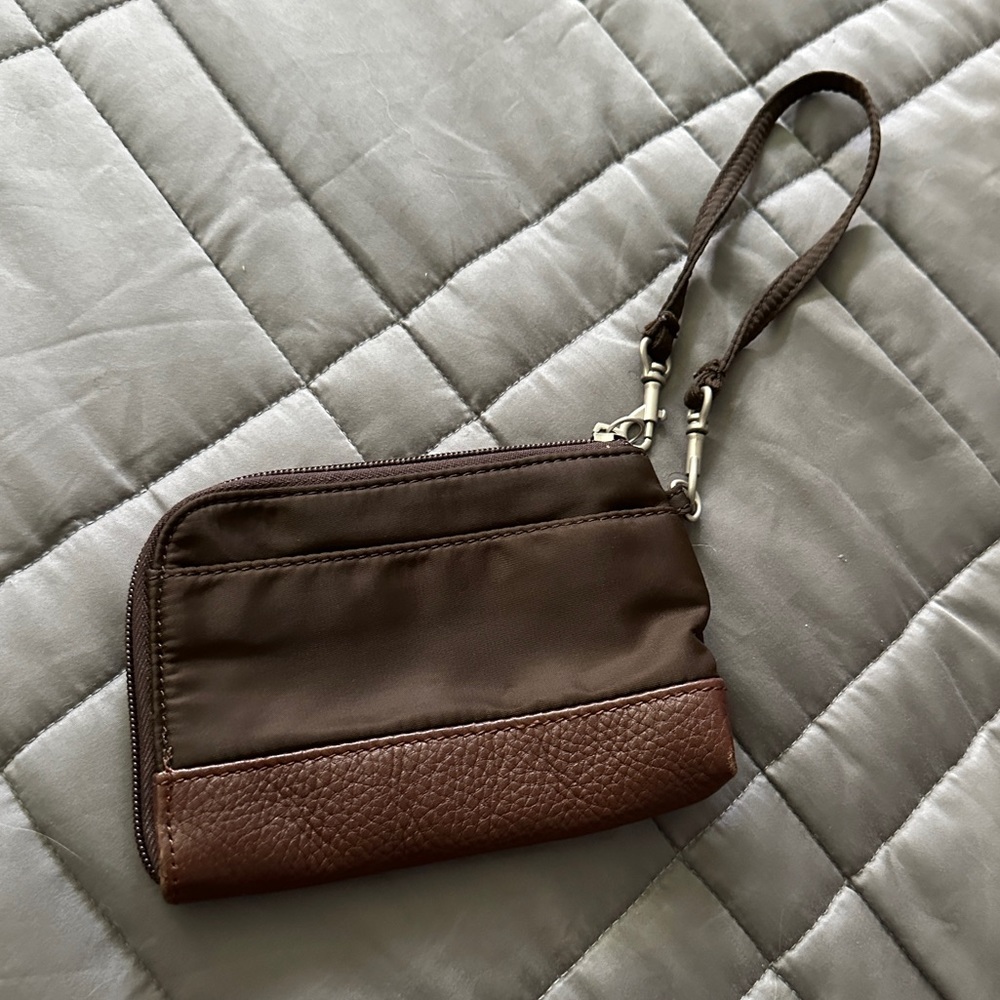 Baggallini nylon and pebble leather wristlet. Zip closure, inside card pockets.